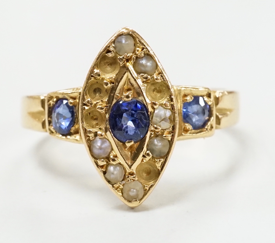 An early 20th century yellow metal, sapphire and seed pearl set marquise cluster ring (pearls missing), size L/M, gross weight 3.6 grams.